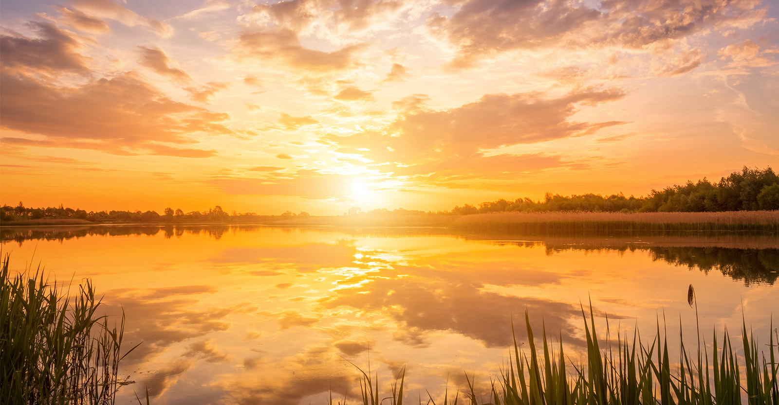 Sunrise over water at the start of autumn
